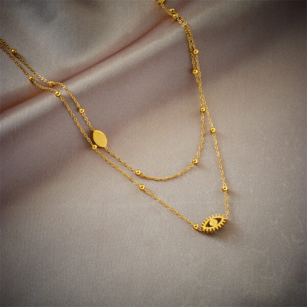 European and American niche fashion design double-layer mixed chain gold bead titanium steel drip oil hollow blue eye pendant necklace - Image 2