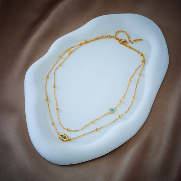 European and American niche fashion design double-layer mixed chain gold bead titanium steel drip oil hollow blue eye pendant necklace - Image 3